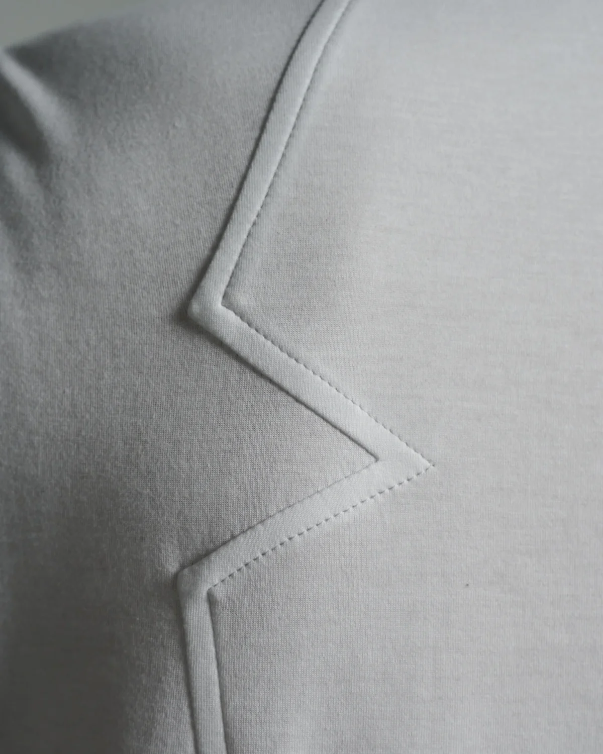 Bib Fronted V-neck with Panelled Shapes